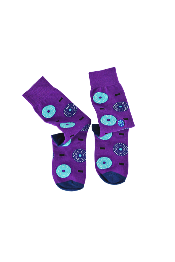 Purple socks. The Ghanaian name for the textile that inspired this design is Nsu Bra, an Akan word meaning "water well". The tiny dots are meant to resemble the ripples that are formed after water has been fetched.

In Nigeria, it is referred to as "disk" or "record" for obvious reasons. 

In Togo, it is known as Gbedze, which references the straw hats worn as protection from the sun by royalty.